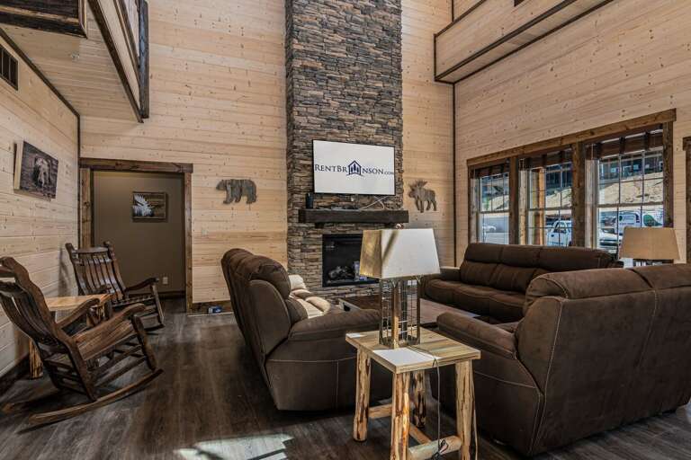 Living Room With Fireplace, Sofas, And Wooden Walls