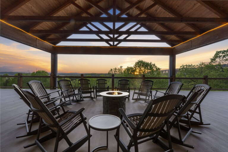 Outdoor Seating Area With Chairs Around A Fire Pit At Dusk