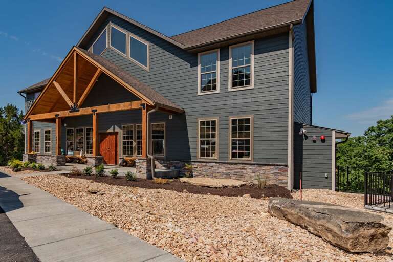 Two-story House With Wooden Accents And Blue Siding