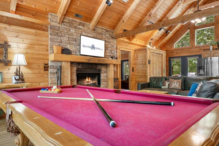 Wood-paneled Living Space With Fireplace And Pool Table