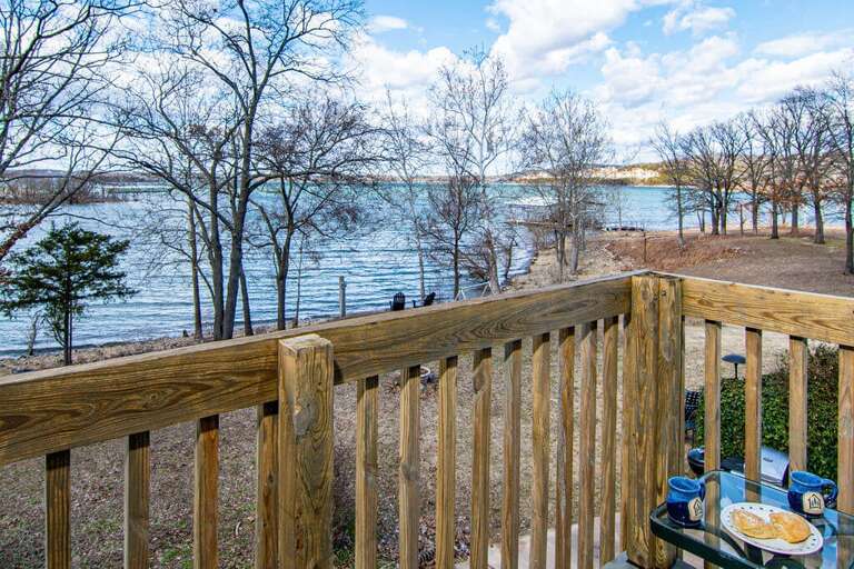 Lake View From Balcony With Railing And Outdoor Breakfast Setup