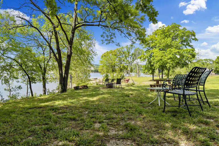 Lakeside Seating Area With Chairs And Greenery