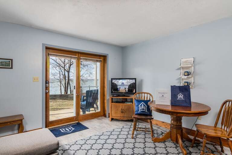 Lake View Room With Dining Table, Chairs, And Sliding Door To Outside Lake View Room With Dining Table, Chairs, And Sliding Door To Outside