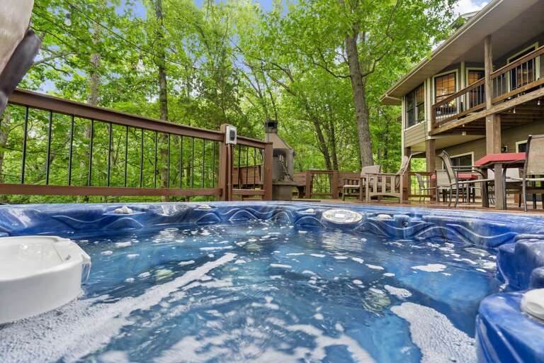 Outdoor Hot Tub With Building And Trees In Background Outdoor Hot Tub With Building And Trees In Background