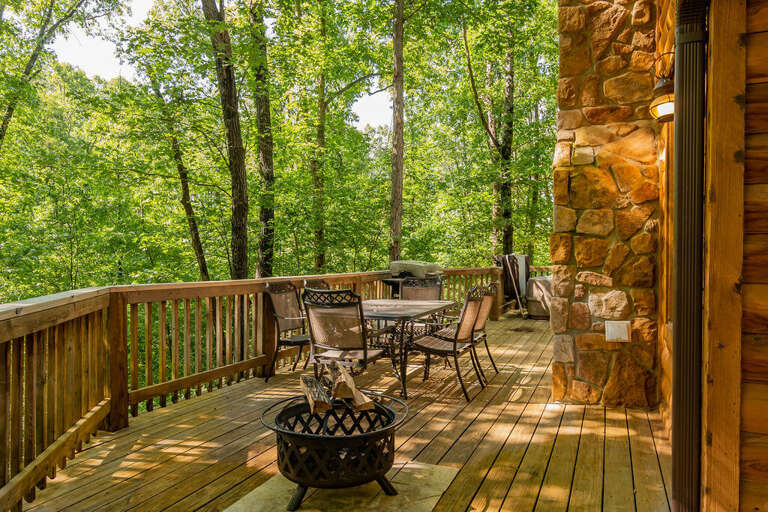 Wooden Deck With Furniture Surrounded By Trees