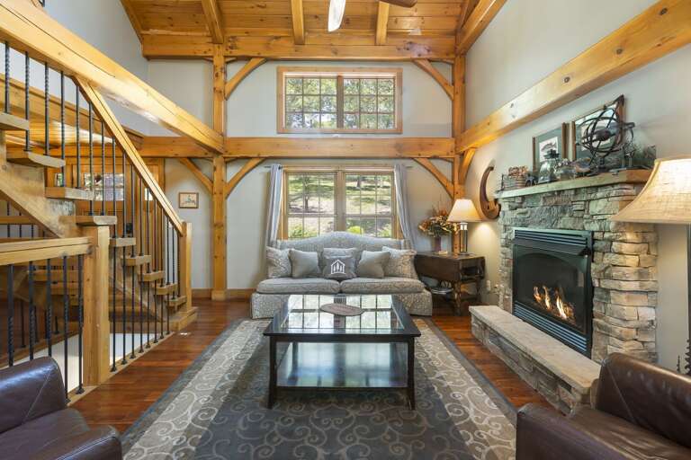 Living Room With Fireplace, Staircase, And High Ceiling Living Room With Fireplace, Staircase, And High Ceiling