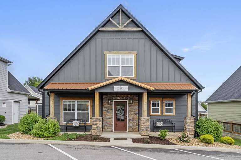 Two-story Residential Building With Gray Siding And Stone Accents