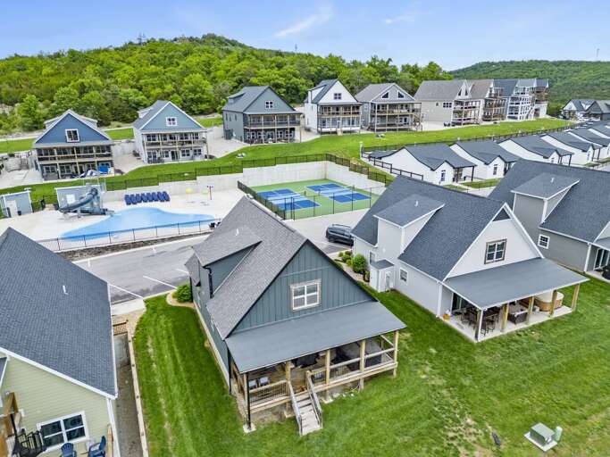 Suburban Neighborhood With Homes And Swimming Pool Aerial View
