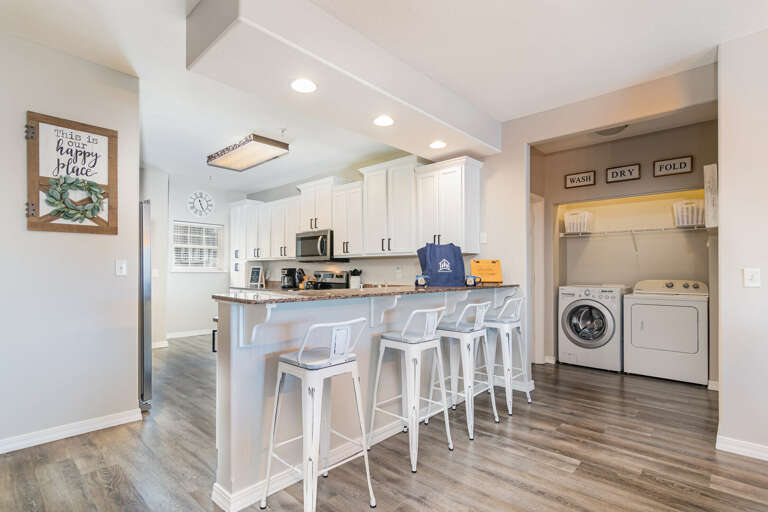 Interior Of A Kitchen With Island And Laundry Appliances In A Vacation Rental