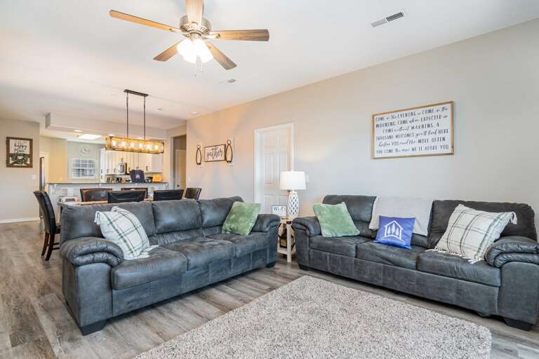 Living Room With Sectional Sofas And Ceiling Fan