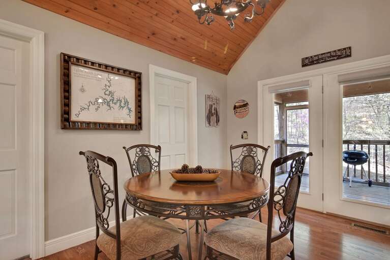 Dining Area With Table, Chairs, And Chandelier