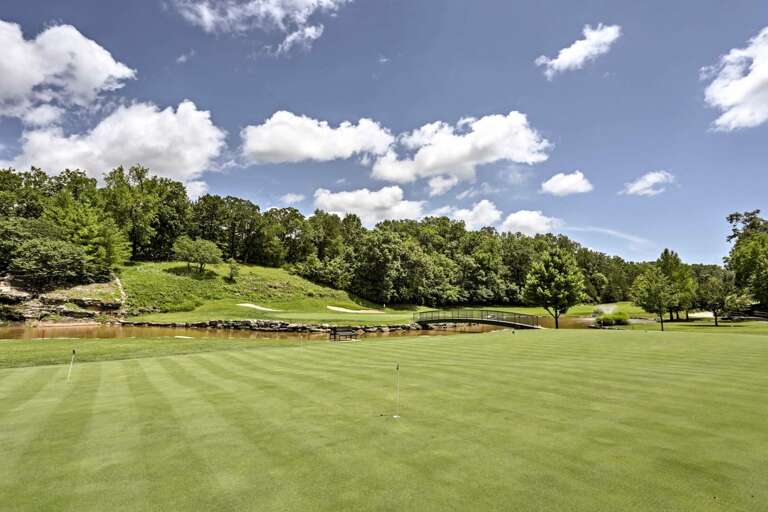 Golf Course With Green Grass And Blue Sky