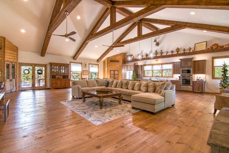 Spacious Living Room With Wooden Beams And Open Kitchen Layout