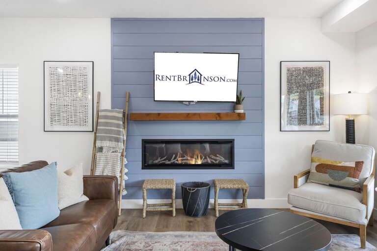 Living Room With Television Above Fireplace And Furniture