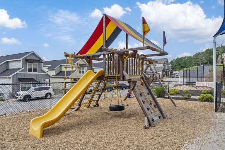 Playful Playground Poles, Vibrant Slides, Swings Swaying; Backdrops Of Buildings