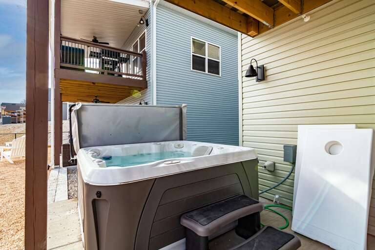 Outdoor Hot Tub Beside House With Balcony