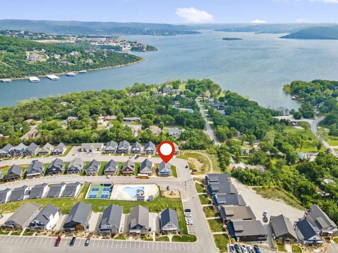 Aerial View Of Lakeside Residential Area With Red Pin Marker
