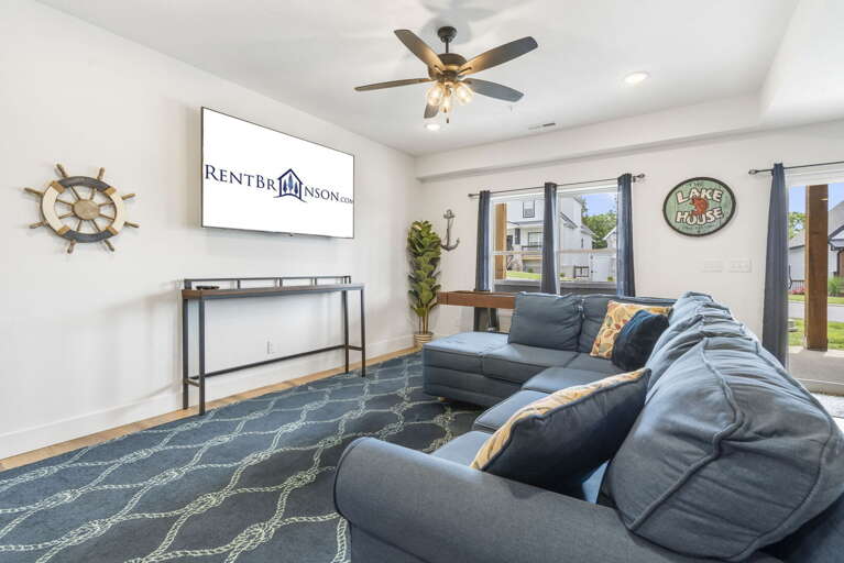 Living Space With Large Sofa And Television, Decorated With Nautical Theme