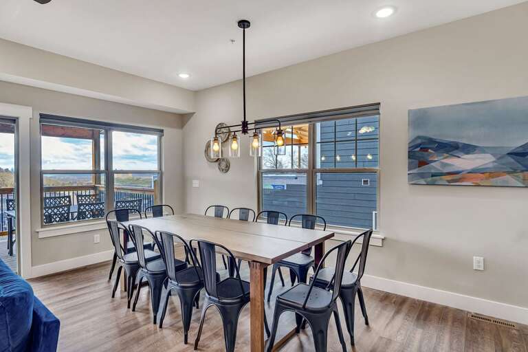 Dining Room With Large Table, Chairs, And Chandelier Dining Room With Large Table, Chairs, And Chandelier