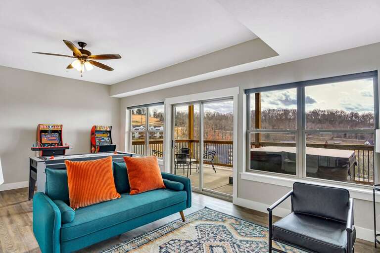 Living Room With Blue Sofa, Chair, And Balcony Access