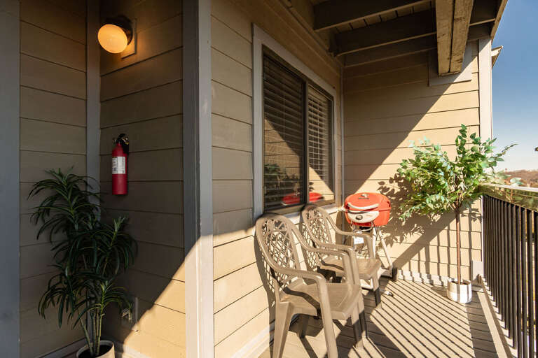 Balcony With Chairs And Grill At Vacation Rental Balcony With Chairs And Grill At Vacation Rental