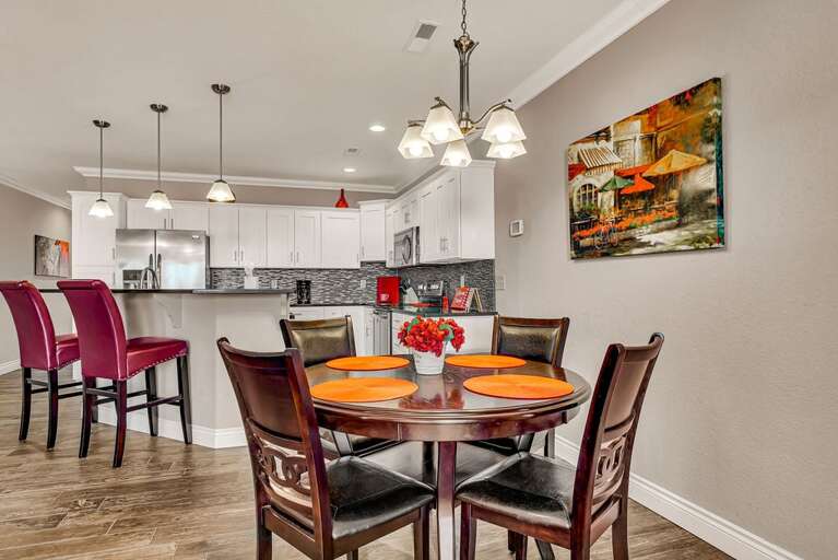 Residential Dining Area With Table Set And Kitchen In Background
