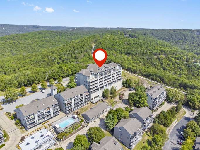 Aerial View Of A Large Building Amid Green Woods