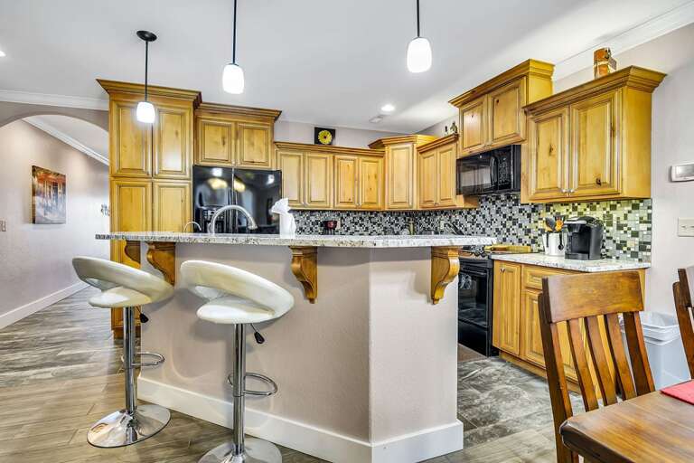 Kitchen Interior With Wooden Cabinets And Bar Stools