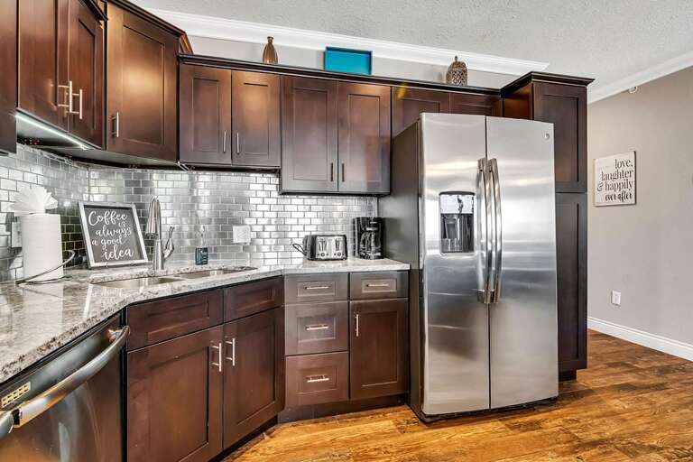 Interior Of A Kitchen With Stainless Steel Appliances And Wooden Cabinets
