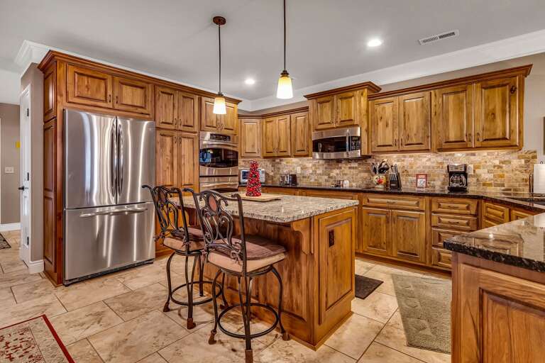 Residential Kitchen Interior With Wooden Cabinets And Stainless Steel Appliances