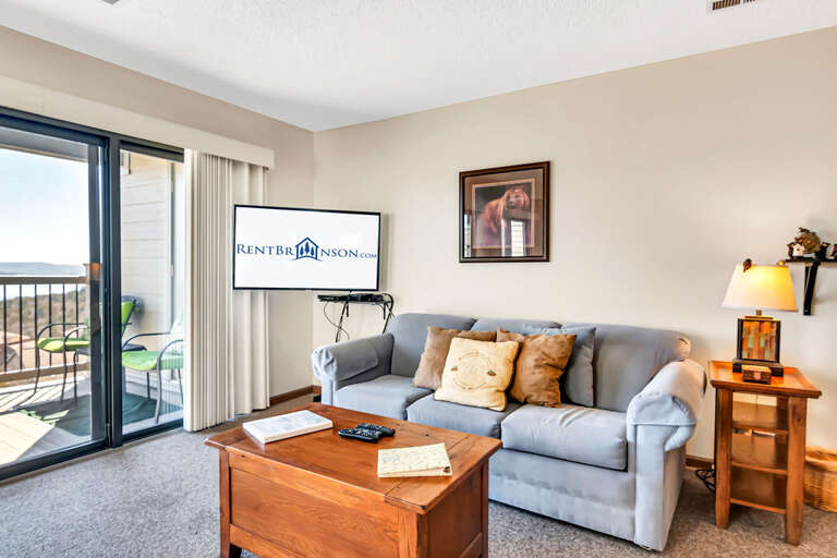 Living Room With Sofa, TV, And Balcony Access Living Room With Sofa, TV, And Balcony Access