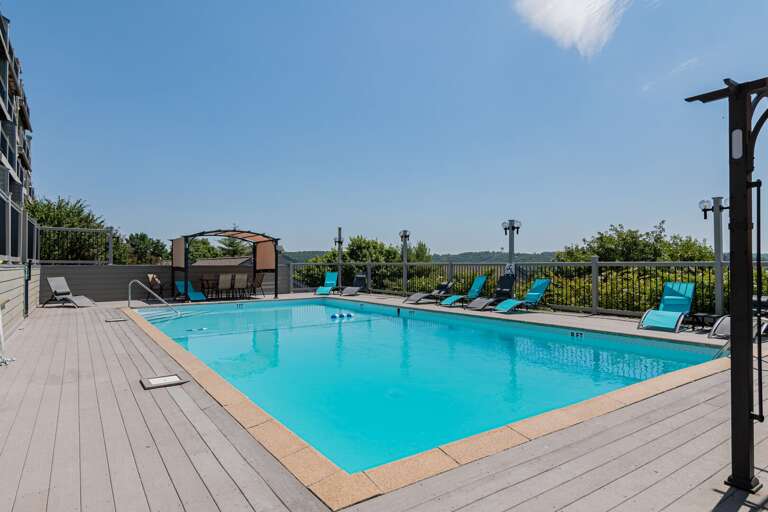 Outdoor Pool With Lounge Chairs And Clear Sky
