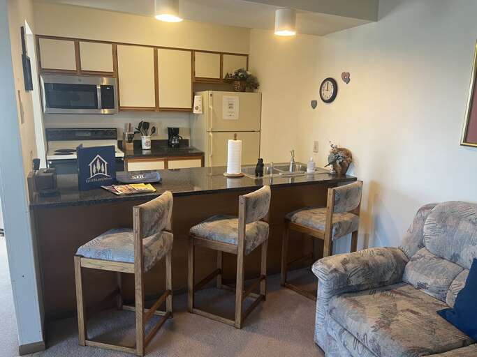 Interior Of A Vacation Rental With Kitchenette And Seating Area