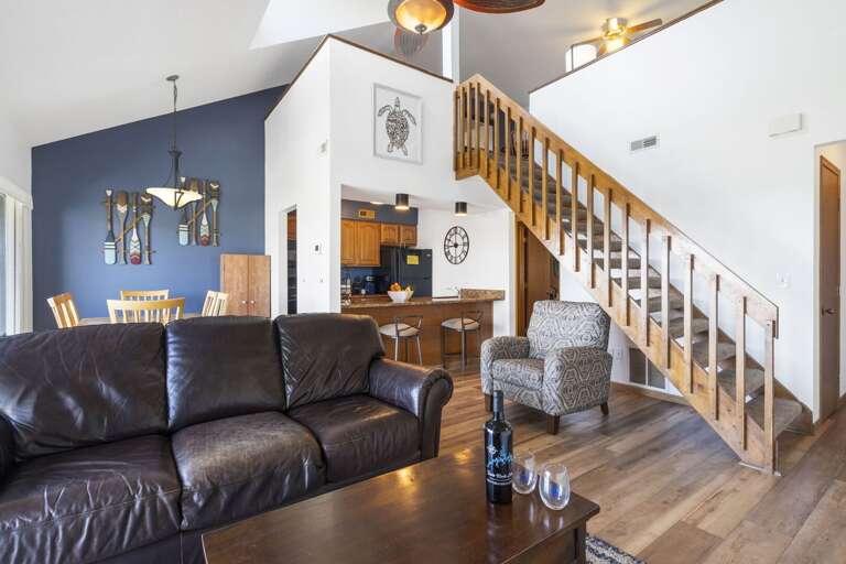 Interior Living Space With Staircase And Kitchen