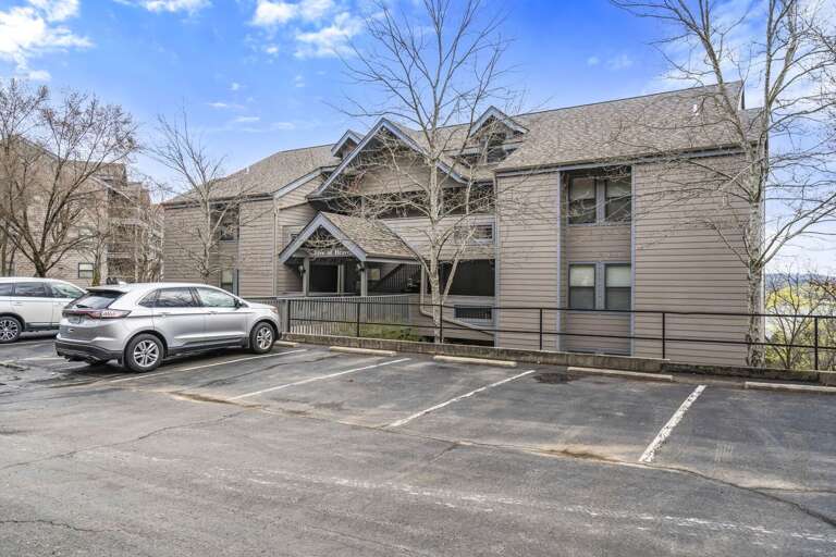 Residential Building With Parking Lot And Vehicles