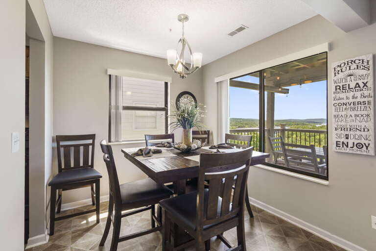 Dining Room Interior With Table, Chairs, And A View Of The Outdoors
