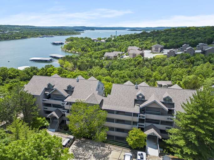 Aerial View Of Lakeside Residential Buildings Surrounded By Trees