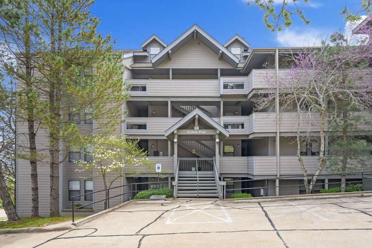 Multi-story Residential Building With Parking Lot In Front Multi-story Residential Building With Parking Lot In Front