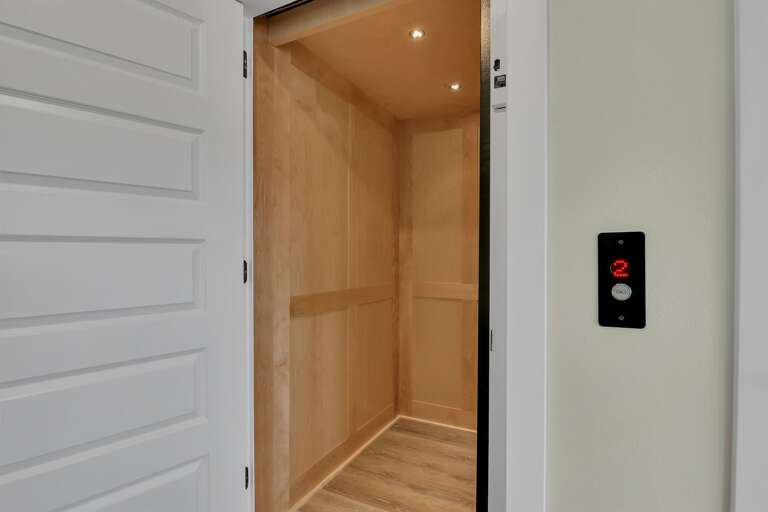 Open Elevator With Wooden Interior, Illuminated Panels Open Elevator With Wooden Interior, Illuminated Panels