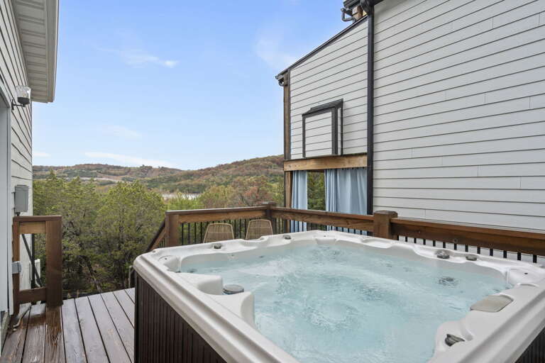 Balcony View With Bubbling Hot Tub Overlooking Lush Valley