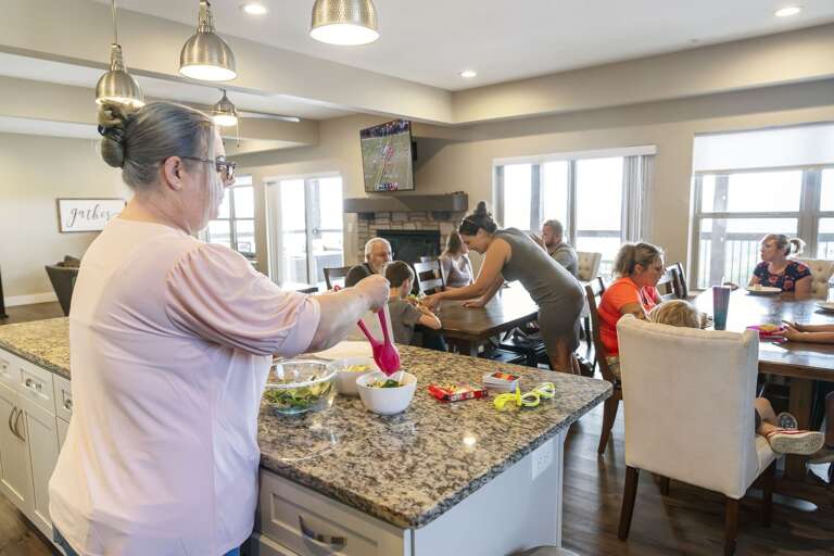 Family Gathering In Spacious Kitchen, Preparing Food And Dining Together