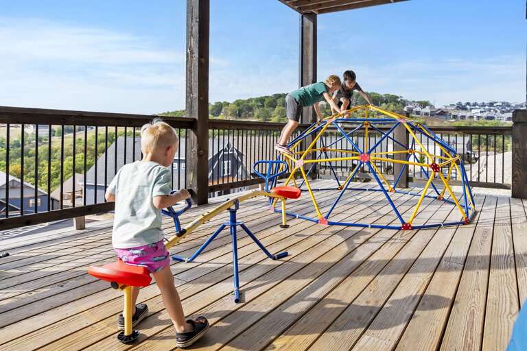 Children Playing On Playground With Scenic Backdrop Children Playing On Playground With Scenic Backdrop
