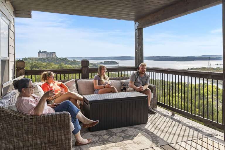 Four Friends Relaxing On Balcony, Breezy View Of Bay And Bridge