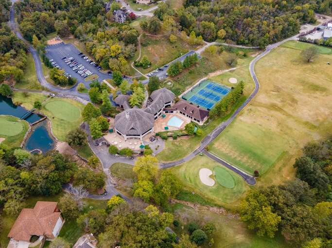 Aerial View Of A Residential Complex With Pool And Tennis Court Aerial View Of A Residential Complex With Pool And Tennis Court