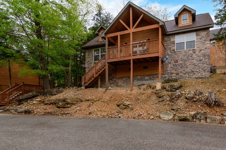 Residential Building With Balcony And Stone Facade In Forest Setting Residential Building With Balcony And Stone Facade In Forest Setting