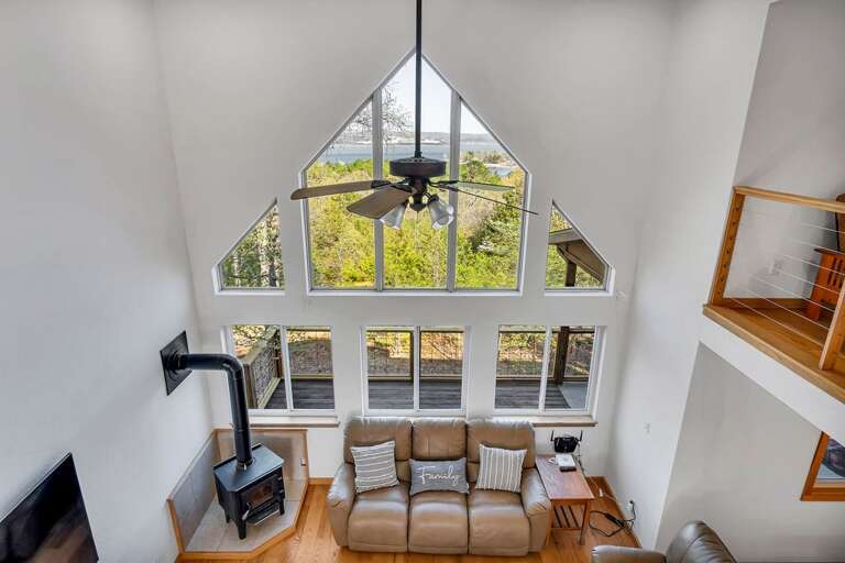 Interior View Of A Living Room With High Ceiling And Fireplace, Overlooking Nature Interior View Of A Living Room With High Ceiling And Fireplace, Overlooking Nature