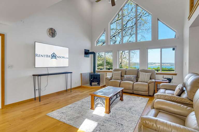 Spacious Living Room With Large Windows And Waterfront View Spacious Living Room With Large Windows And Waterfront View