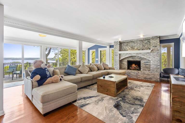 Interior Living Space With Person On Couch And Fireplace