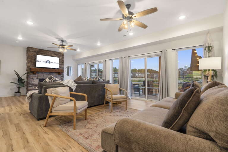 Living Room Interior With Sofas And TV, Leading To Outdoor Patio