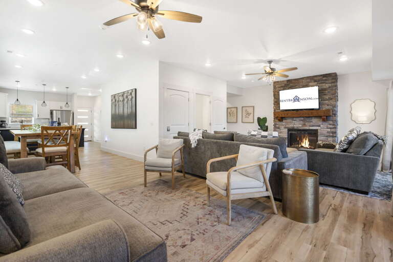 Spacious Living Room With Kitchen, Dining Area, And Fireplace